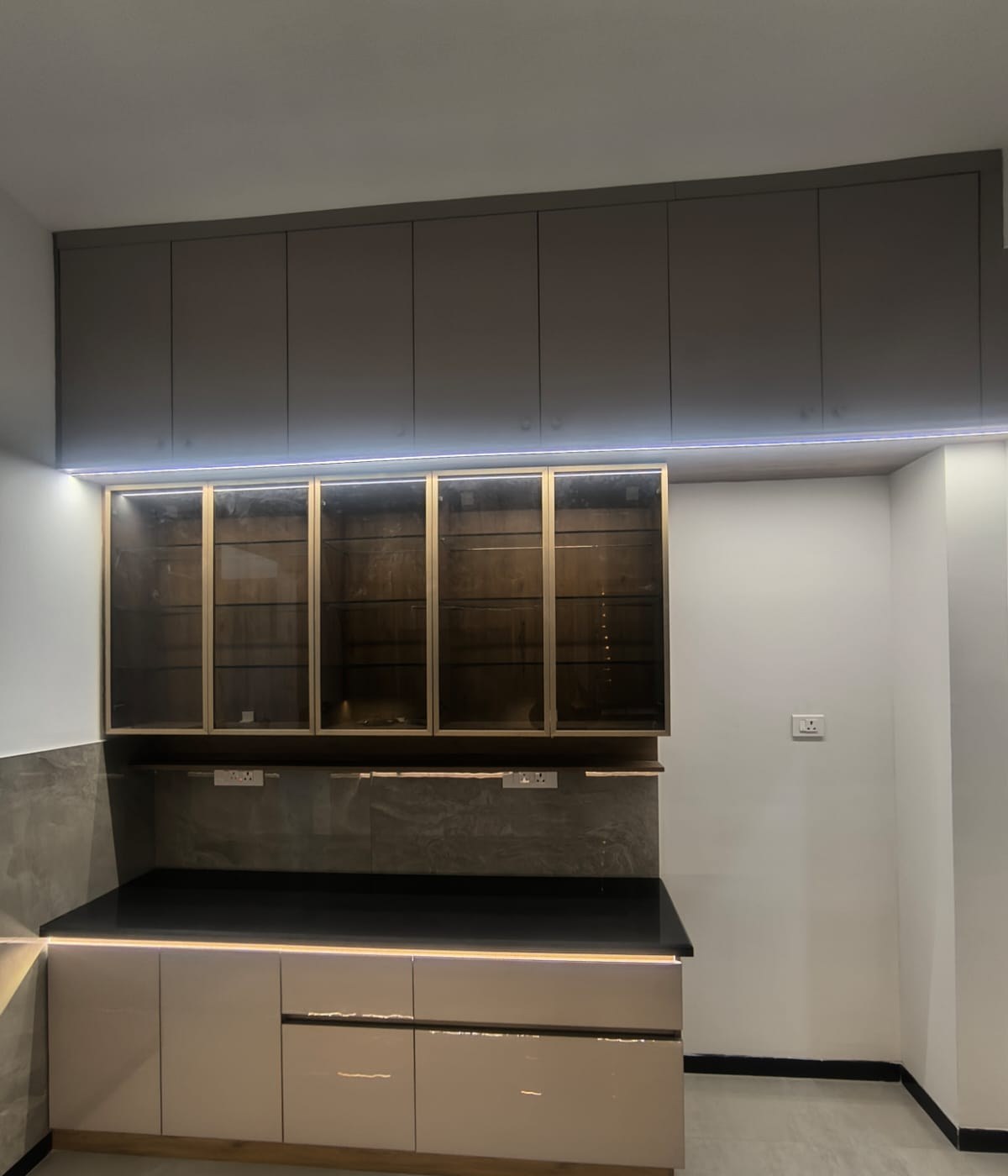 Backlit glass crockery unit with overhead storage